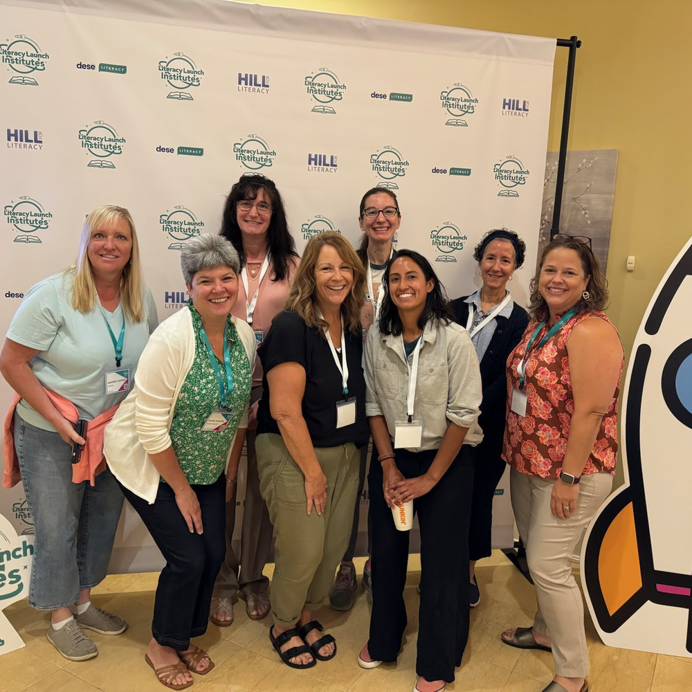 A group of educators pose together smiling at the Literacy Launch Institute