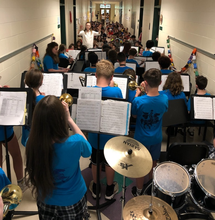 LBMS students perform in front of music stands for MRE students.