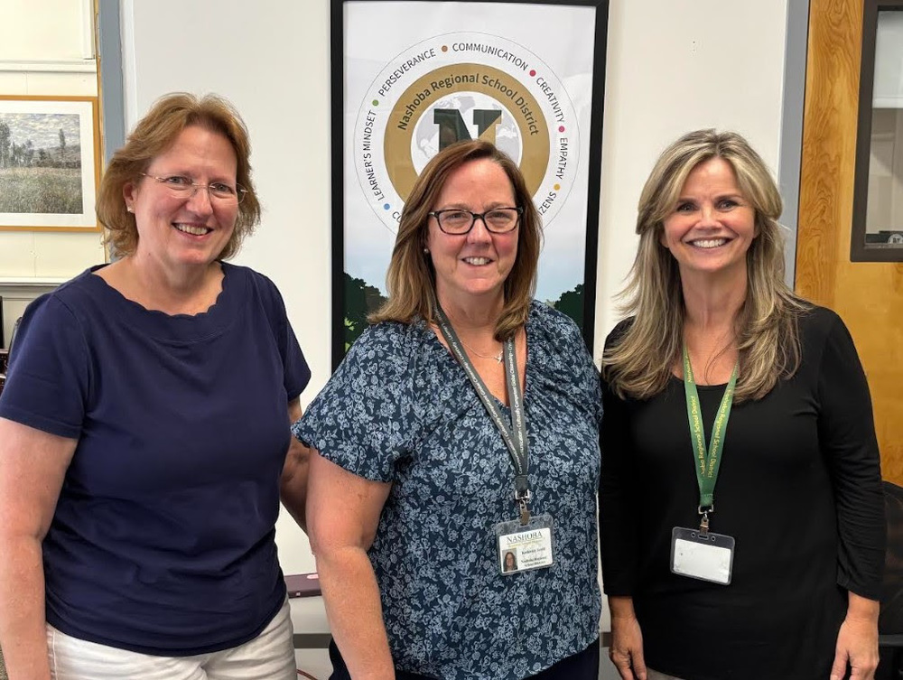 Three members of the Student Services team pose together smiling.