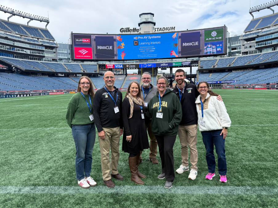 A group of NRSD educators poses together at Gilette Stadium while attending the MassCUE conference.