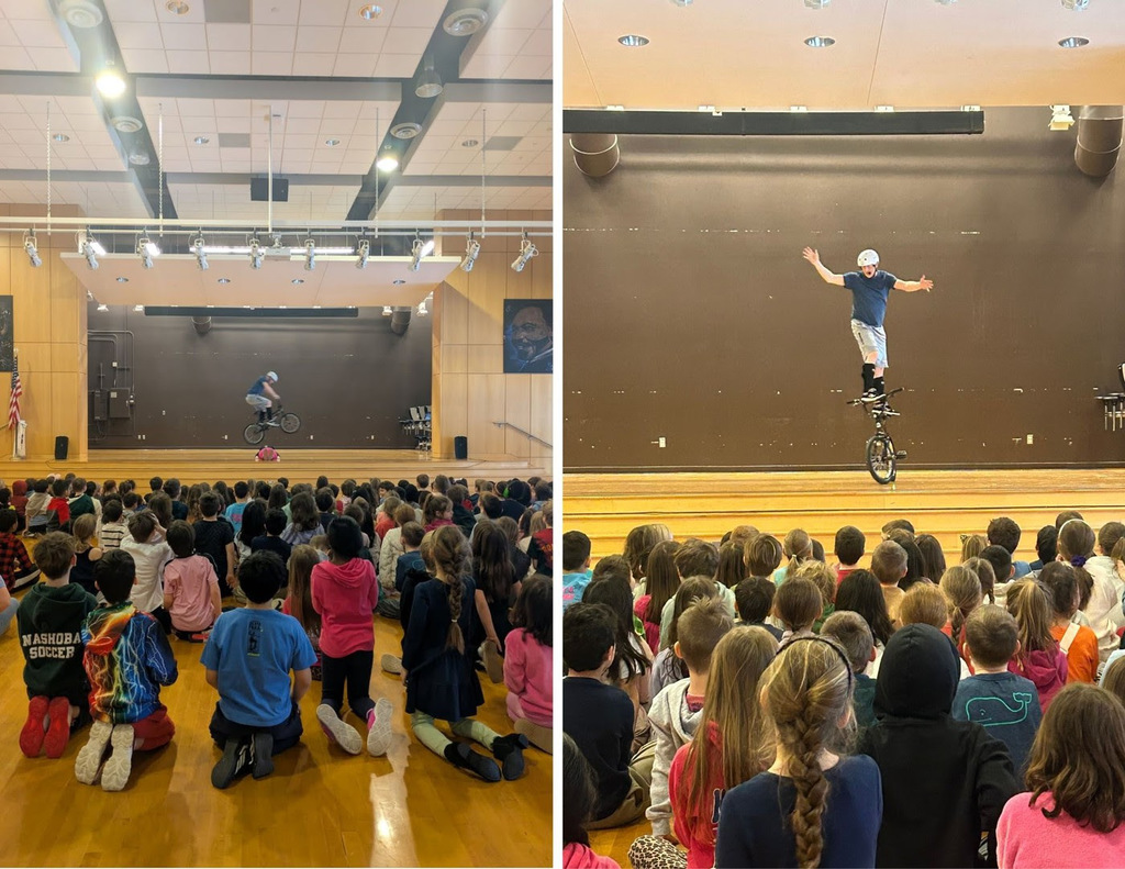 Motivational speaker, Chris Poulos, jumps over a staff member and does tricks with a BMX bike in front of a student audience.