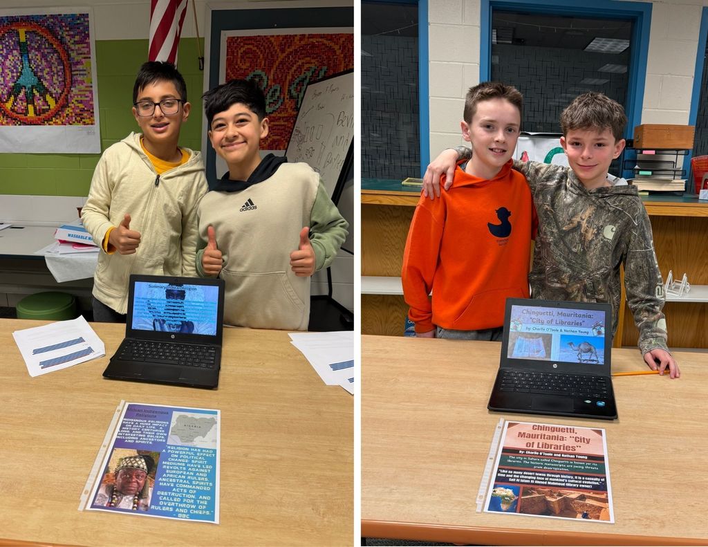 LBMS students stand together in front of chromebooks and flyers about showcasing history.