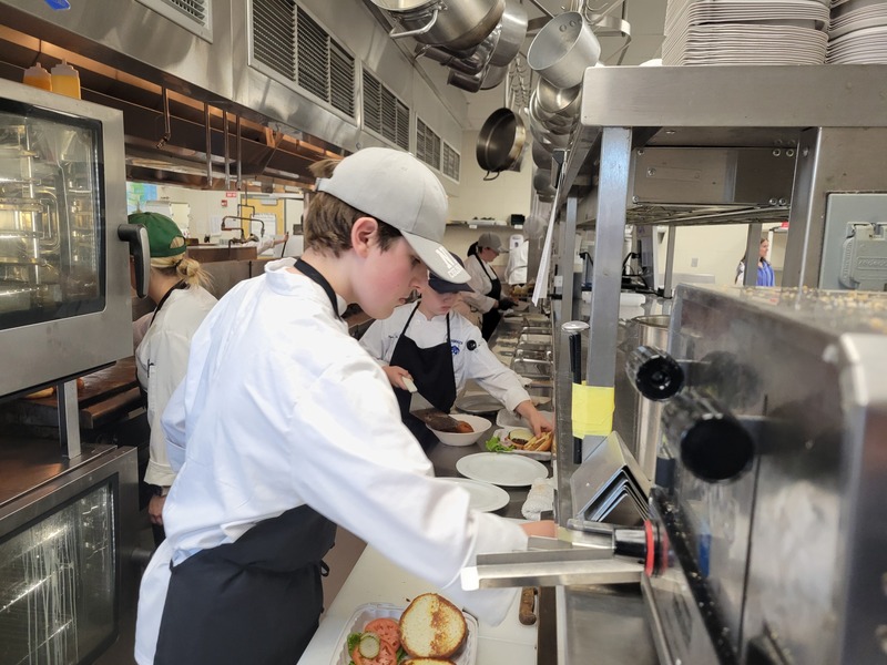 Nolan Manning (sophomore, Groton) prepares lunch in the kitchen at the Viking Bistro at Nashoba Tech.