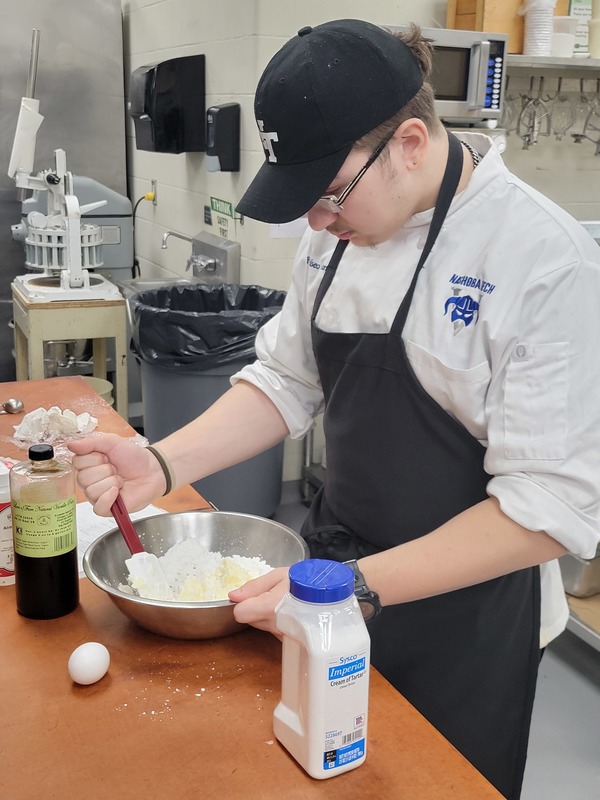Francisco Fornero, a junior from Chelmsford, prepares dessert in the kitchen of The Viking Bistro.