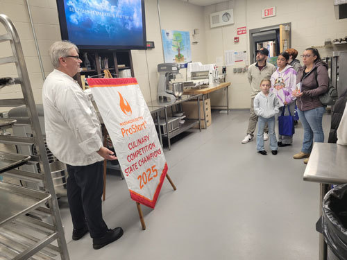 Dennis and Heather Dietrich of Shirley, both graduates of Nashoba Valley Technical High School, listen to chef-instructor Paul Wilson talk about the Culinary Arts program with their daughters, eighth-grader Annabelle and 7-year-old Jojo, during the Westford school’s annual Open House on November 2.