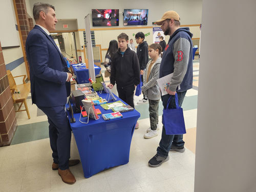 English teacher Bruce Sullivan chats with Leo Romanov of Chelmsford and his children, Ross and Ksemiia, during the annual Open House at Nashoba Valley Technical High School on November 2. Ross is hoping to attend Nashoba Tech next year to study either Programming & Web Development or Carpentry.