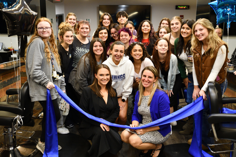 Cosmetology instructors, front from left, Alicia Spinney and Sayda Betsold, and Cosmetology students celebrate the reopening of the new Cosmetology instructional area.
