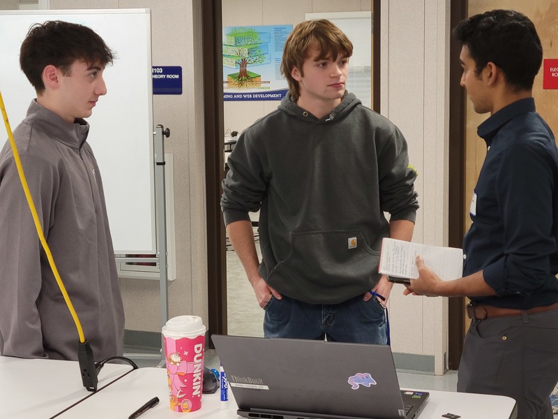 Wall Street Journal reporter Roshan Fernandez, right, interviews Nashoba Tech Engineering Technology student Matthew Fogg (junior, Westford), left, and Robotics & Automation Technology student Dagen Marschhausen (senior, Townsend) about the benefits of a technical education for an article on the growing popularity of technical schools in Massachusetts. 