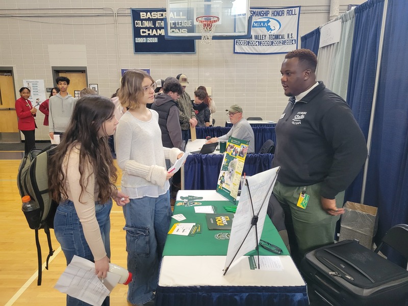 Alyssa Lyons (freshman, Groton), left, and Isabella Picolotto (freshman, Chelmsford) chat with Nana Kumah, assistant director of undergraduate admissions at Fitchburg State University, during a recent Career Fair at Nashoba Tech. (COURTESY NASHOBA TECH)