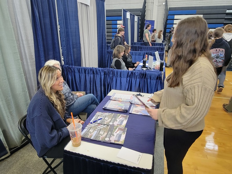 Cheyenne Oborski (sophomore, Littleton) stops at the North Shore Community College booth to chat with Kristen O’Keefe, a senior admissions counselor, during a recent Career Fair at Nashoba Tech. (COURTESY NASHOBA TECH)