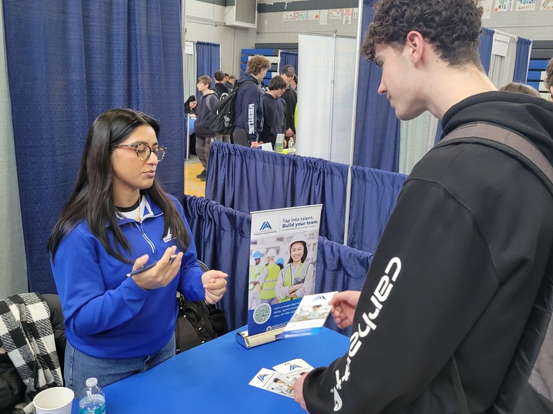 Liam Finley (sophomore, Pepperell) chats with Ammarah Rehman, of the Division of Apprenticeship Standards of the Massachusetts Executive Office of Labor and Workforce Development, during a recent Career Fair at Nashoba Tech. (COURTESY NASHOBA TECH)