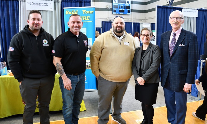 Nashoba Tech Superintendent Dr. Denise Pigeon chats with, from left, Ricardo Xavier and John Burrows of North Atlantic States Regional Council of Carpenters; Jonathan DaSilva, of CVS Health; and Kevin Coughlin, executive director of the MassHire Greater Lowell Workforce Board, the co-sponsor of the Career Fair. (COURTESY NASHOBA TECH)