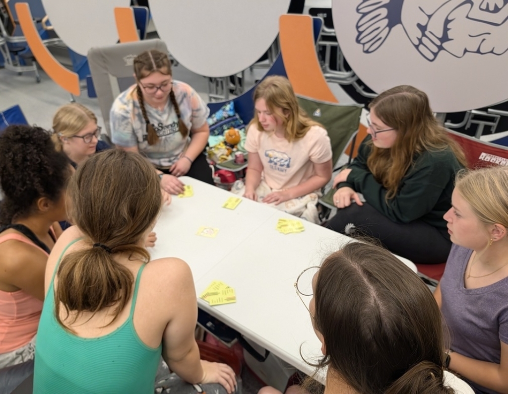 students rocking and playing a card game