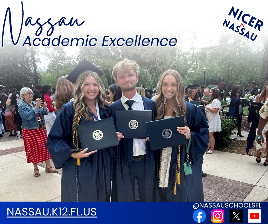 Three high school graduates in navy blue caps and gowns smile while holding their diplomas, standing among a crowd of proud families and friends after graduation.