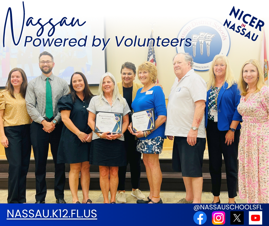 Group photo of Nassau County School District leaders standing with smiling volunteers who were recognized for their service. Two honorees hold framed certificates of appreciation.