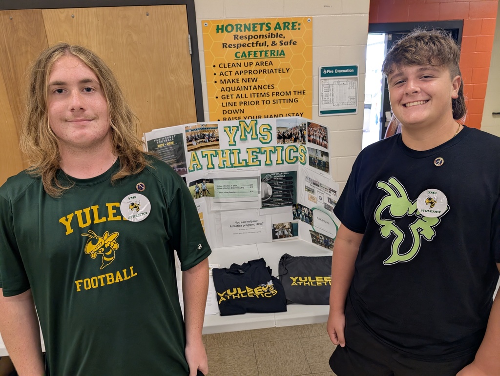 Two students smiling