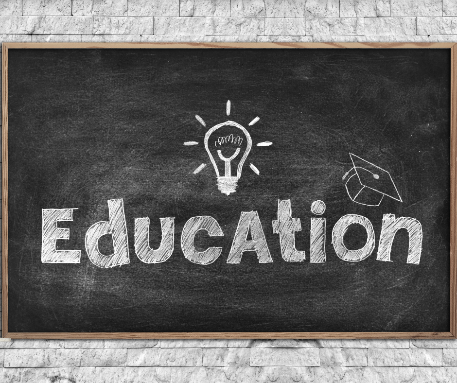 Chalkboard with the word 'Education' written in white chalk, featuring a lightbulb drawing above the letter 'A' and a graduation cap on the letter 'o'.