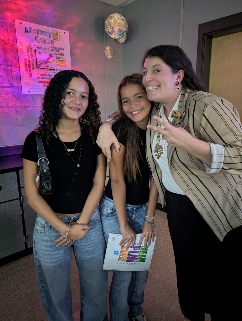 Teacher and two students smiling