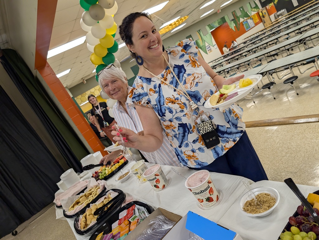 Teachers smiling as they get their breakfast