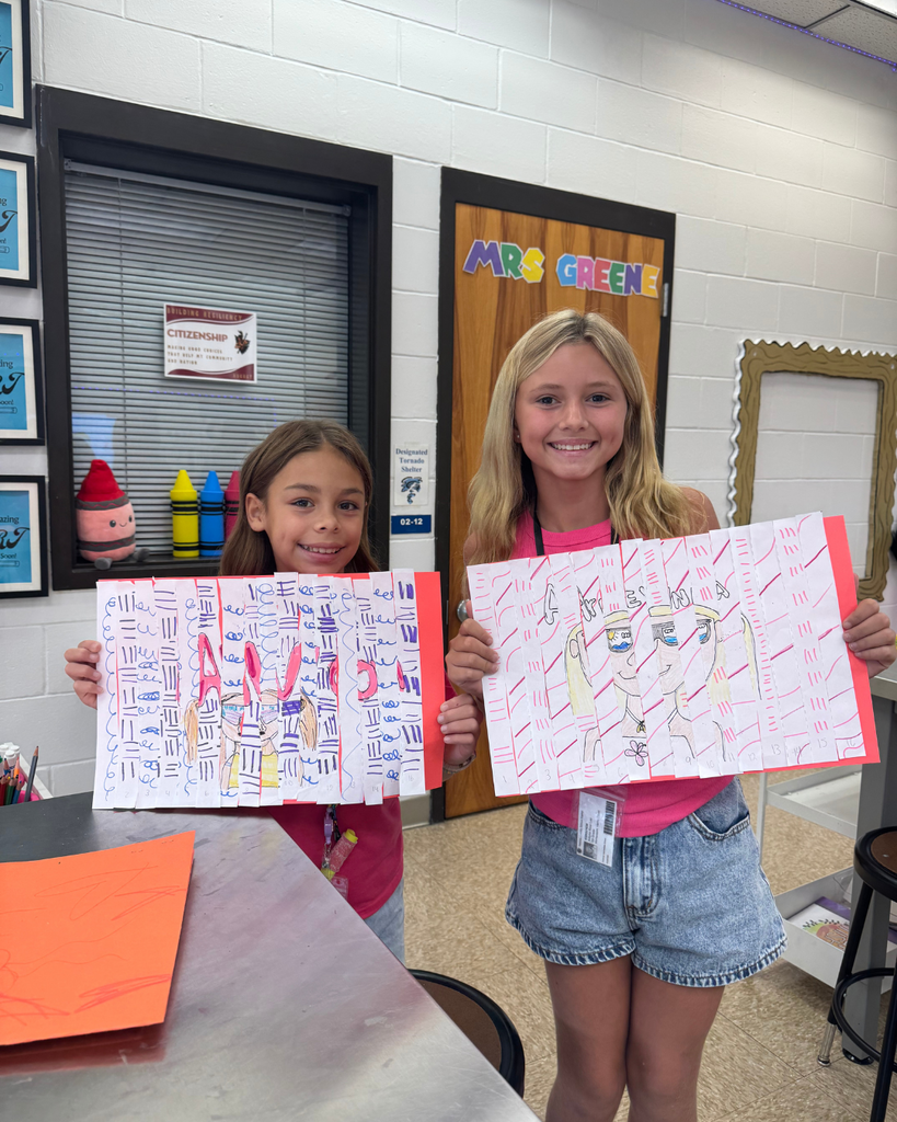 Two students hold agamograph art pieces—one spelling out “Nassau” in bubble letters and the other with a self-portrait sketch—each with zentangle-inspired line patterns.