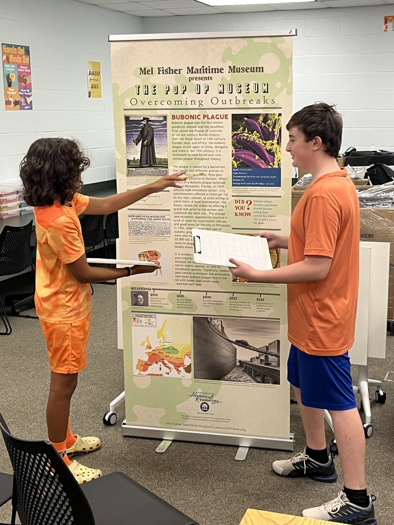 Students studying an exhibit in our pop up museum in the library