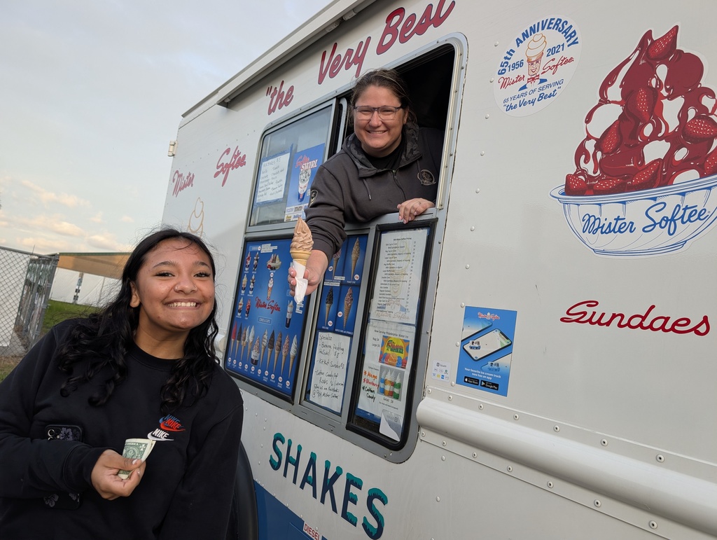 Mr. Softee serving ice cream to a happy student 