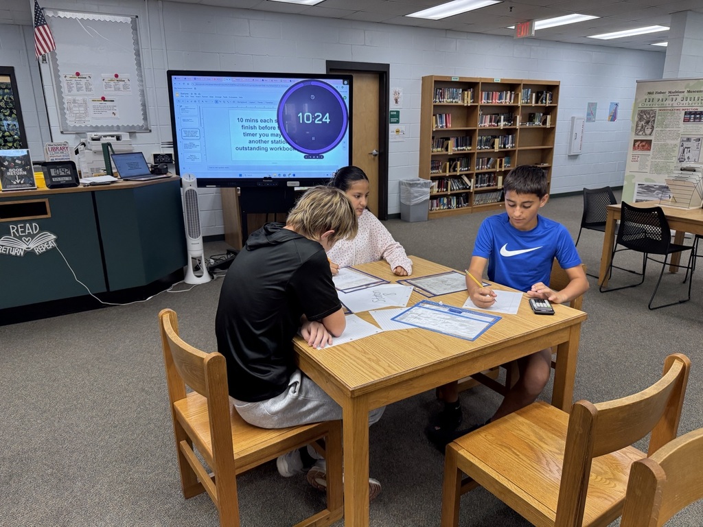 Students working on math in the media center