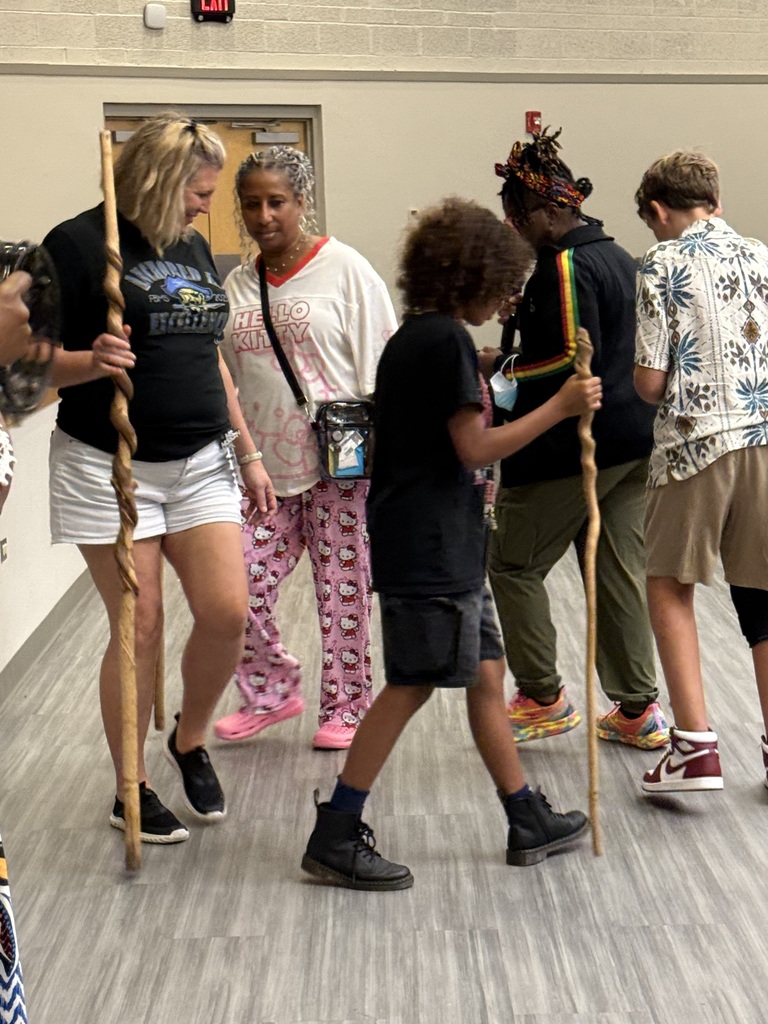 Teachers and students practicing a dance.