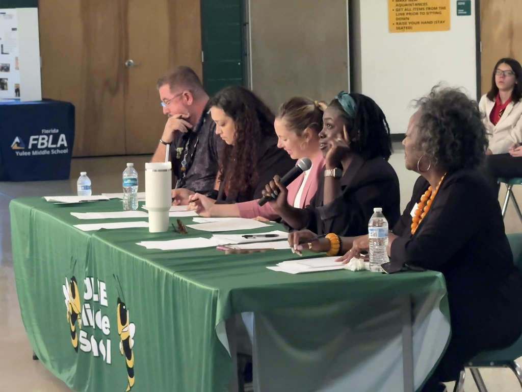 Judges deliberating and speaking to contestants