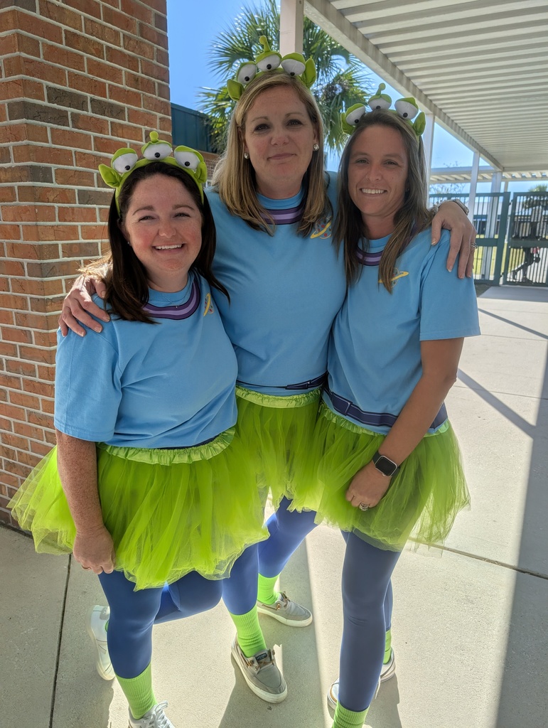 Counselors dressed up as aliens from toy story