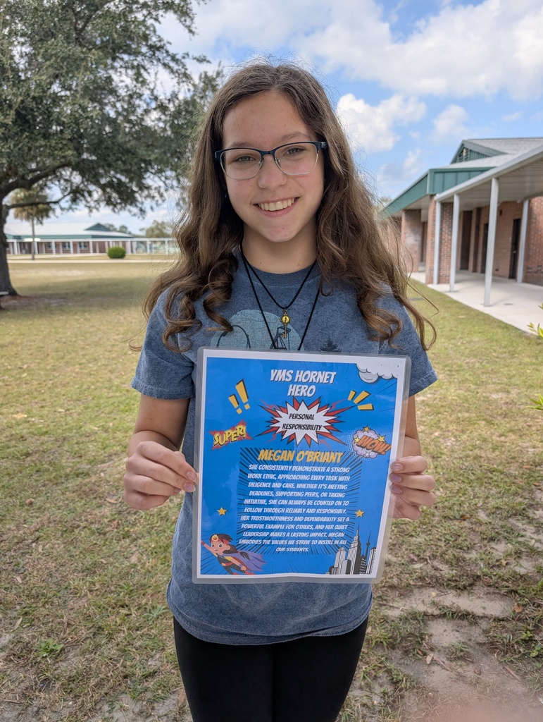 Student who won Resiliency Student of the Month smiling with her award.