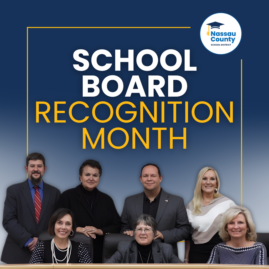 A group photo of the Nassau County School Board members seated and standing in front of a blue background with text reading School Board Recognition Month.
