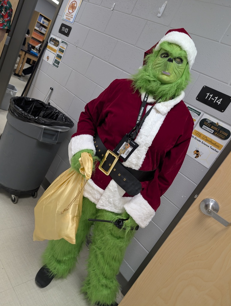 Teacher dressed as the, the, the Grinch!