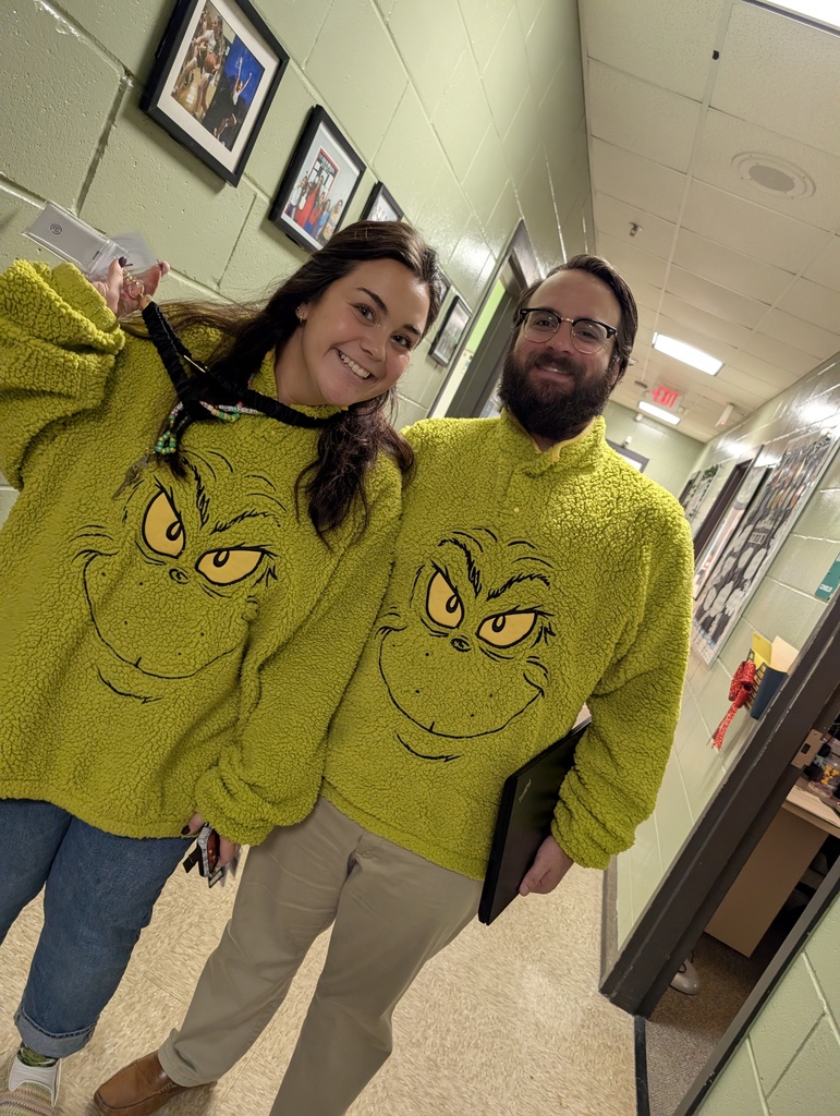 Mr. Goodwin and Ms. Alvare in their matching Grinch sweaters
