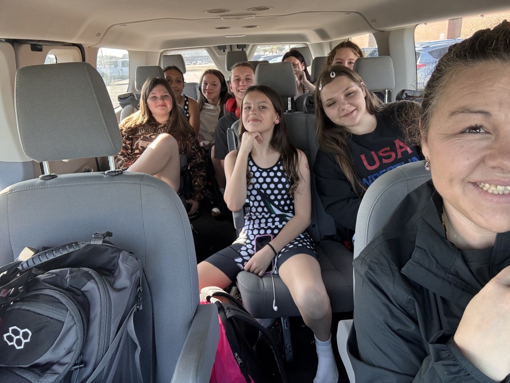 Wrestlers and their coach piled in a van ready to go to their tournament