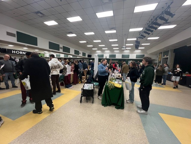 Students and families visit vendor tables and speak with representatives during the College & Career Fair at Yulee High School.
