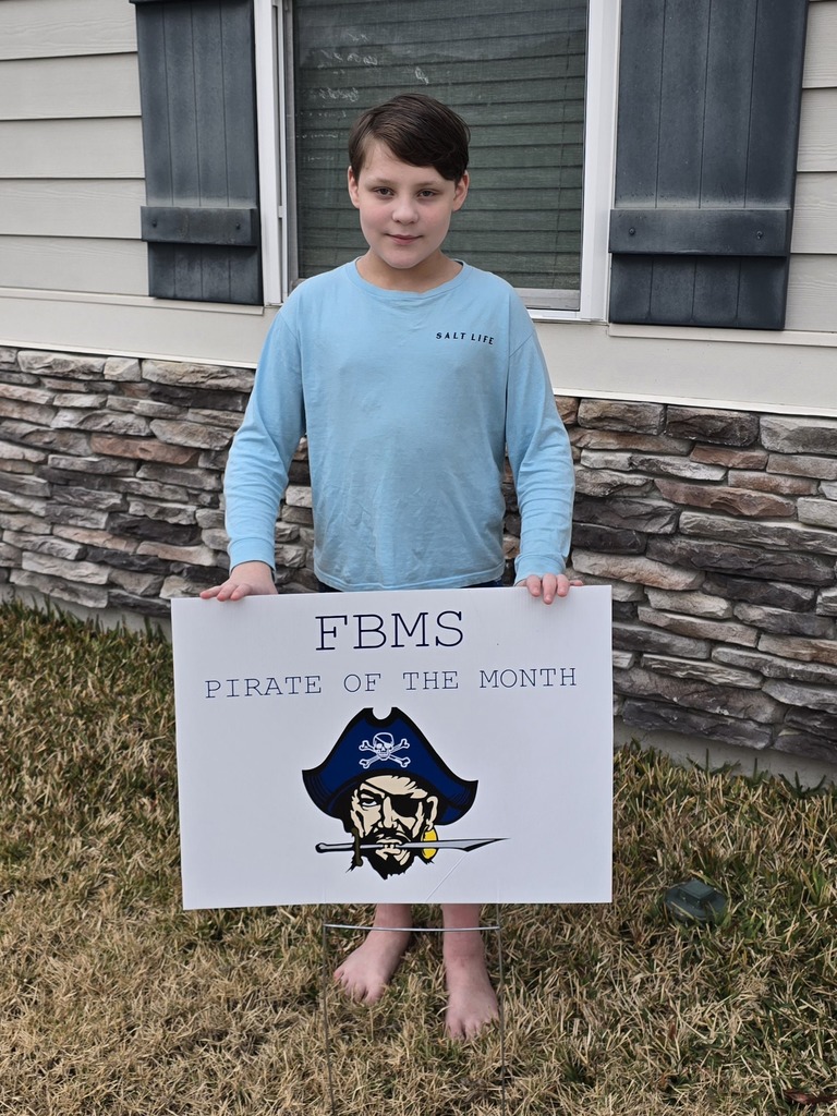Photo of Henry M behind the Pirate of the Month sign.