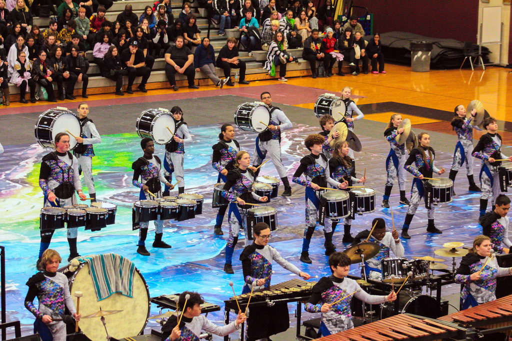 Yulee High School performers combine percussion and choreographed movement on a painted tarp during an indoor competition performance.