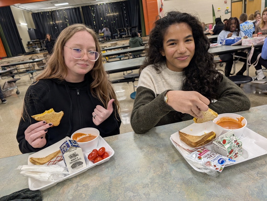 two female student enjoy their tomato soup and grilled cheese on a chilly day
