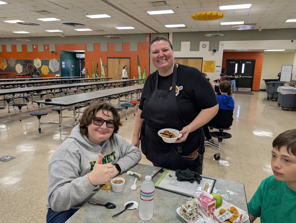 Our Cafeteria manager smiling with a student during lunch