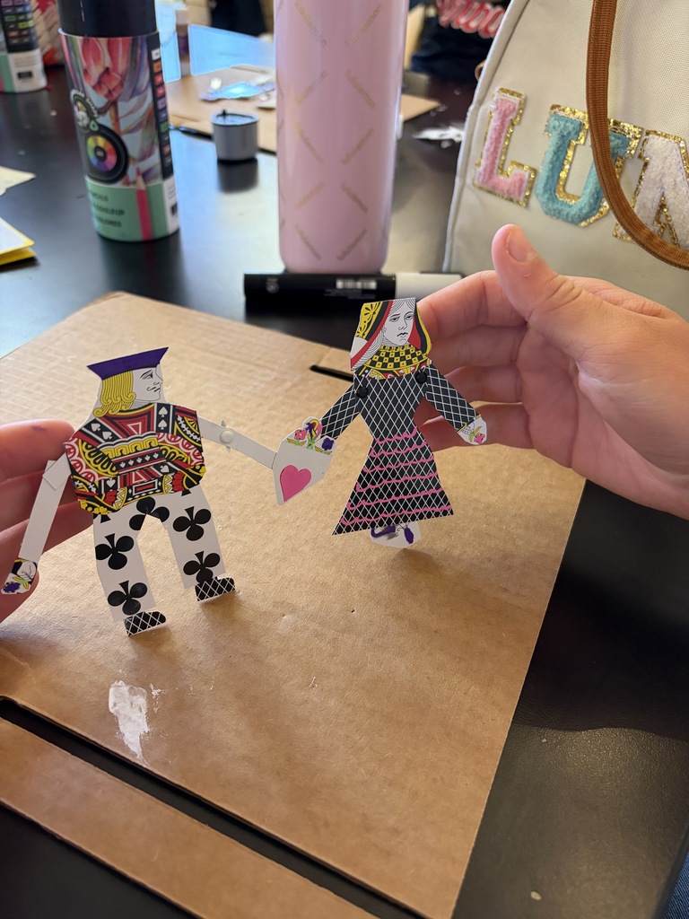 Students displaying artwork.