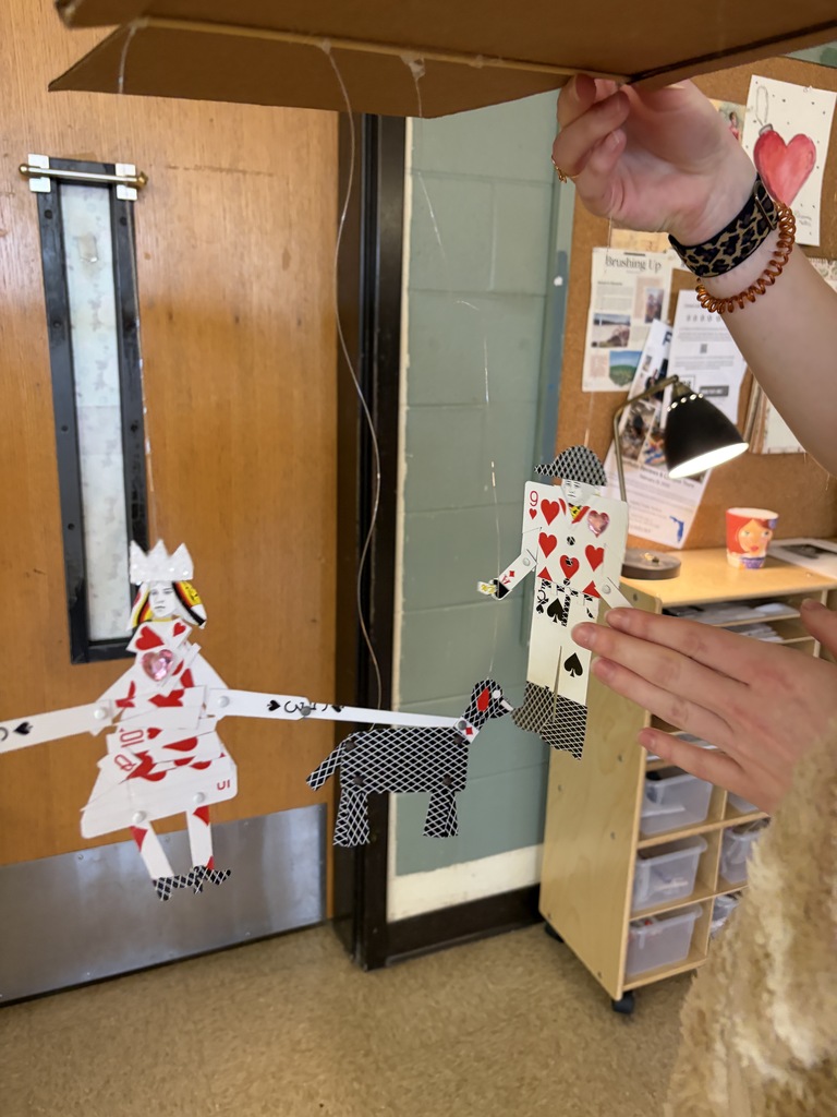 Students displaying artwork.