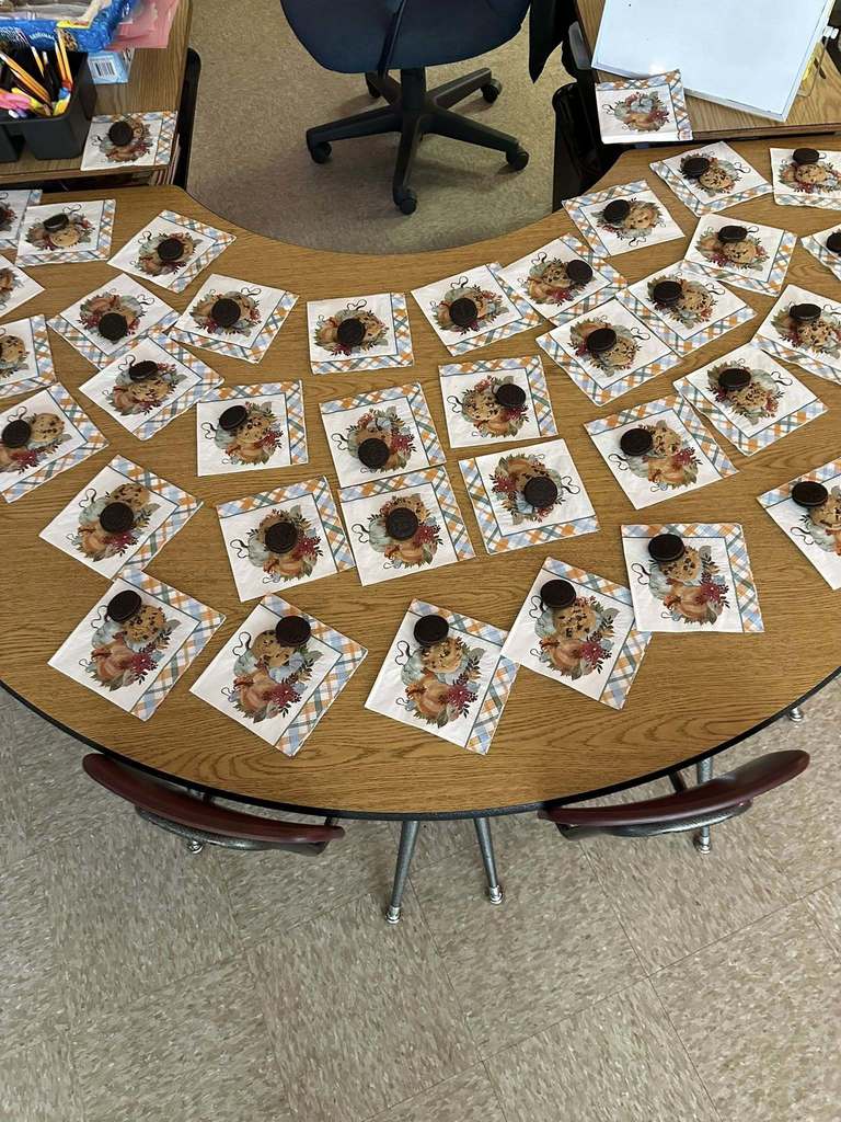 Table covered with napkins, each holding a cookie used for the classroom voting activity.