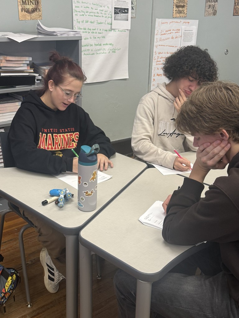 Students sitting at desk writing.
