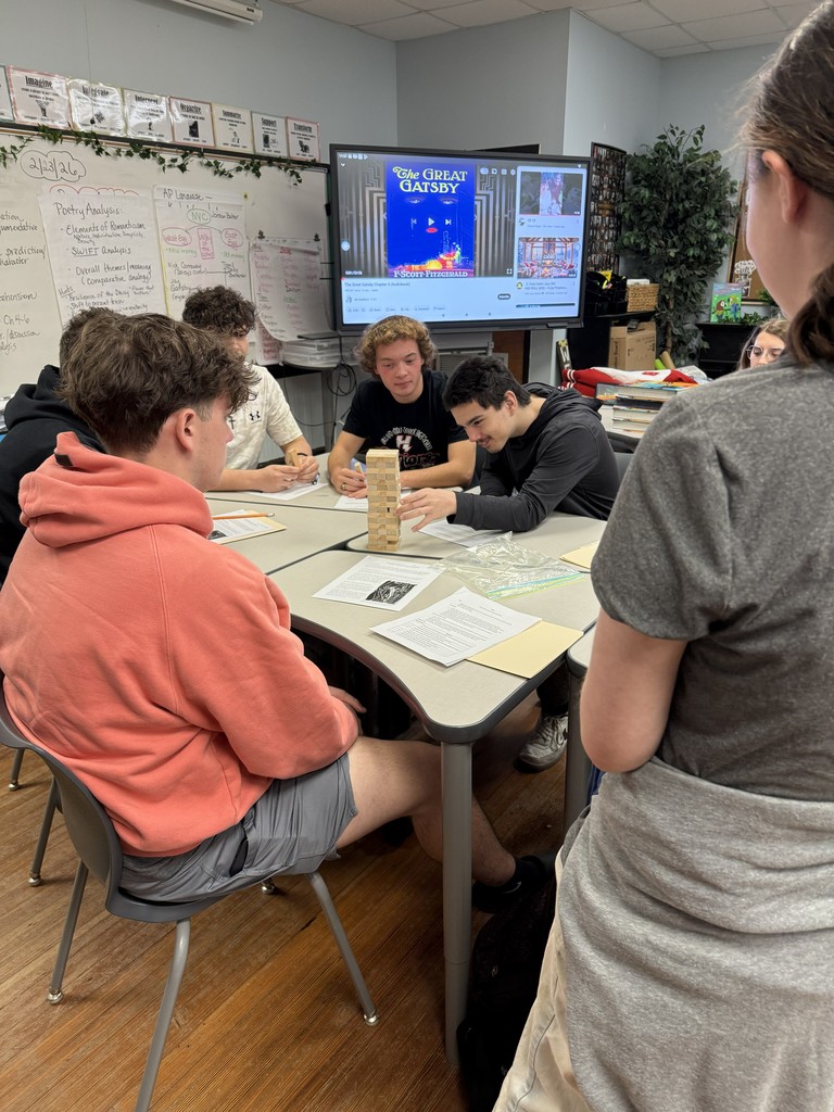 Students playing Jenga while working on a worksheet.