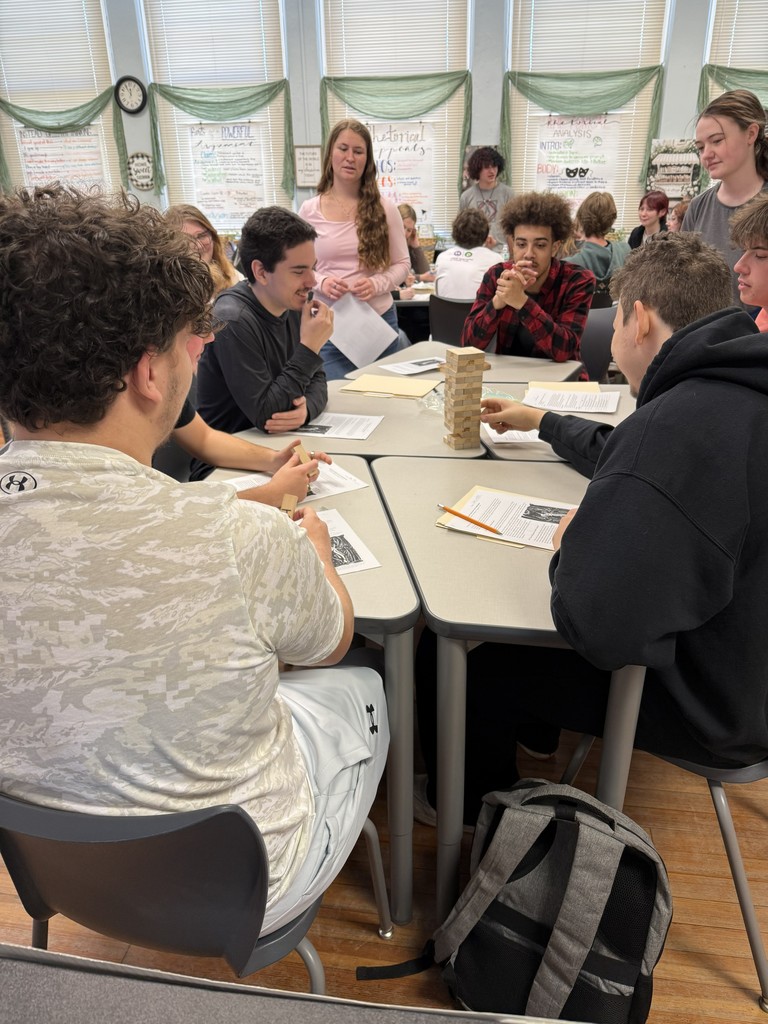 Students playing Jenga while working on a worksheet.