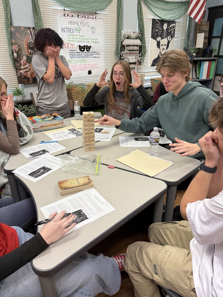 Students playing Jenga while working on a worksheet.
