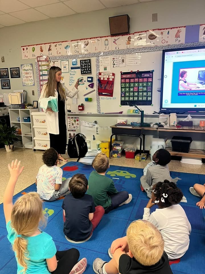 Dr. Porter showing students proper dental hygiene presentation.