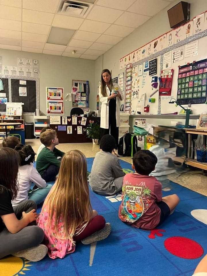 Dr. Porter showing students proper dental hygiene presentation.