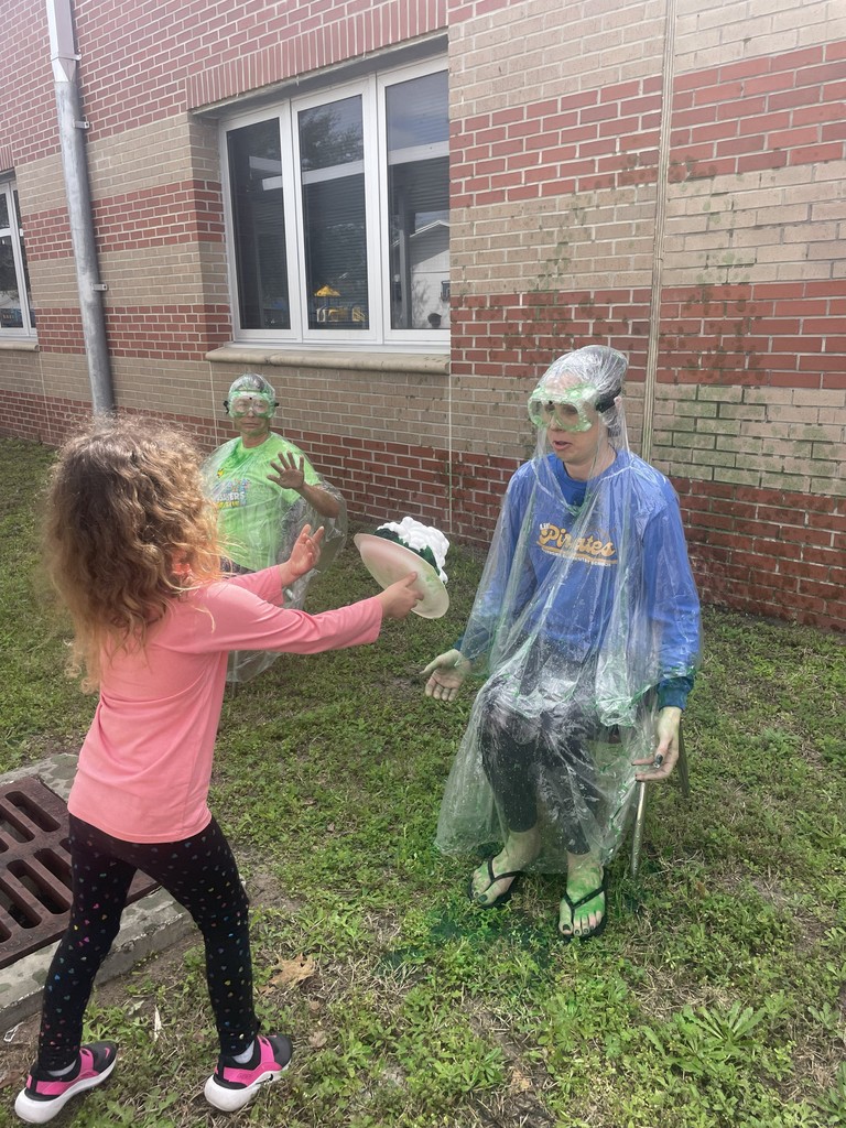 Student throwing shaving cream pie at Dr. Weber.